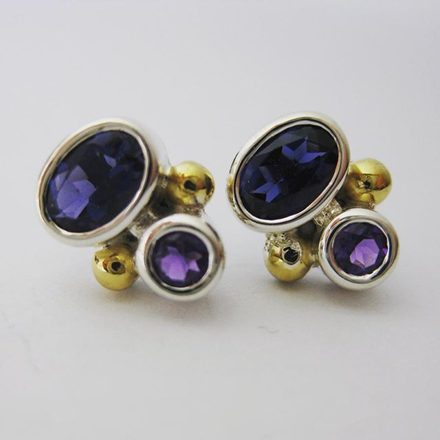 Now showing @manyunggallery sterling silver stud earrings featuring oval iolite and round amethysts with 22ct gold granules