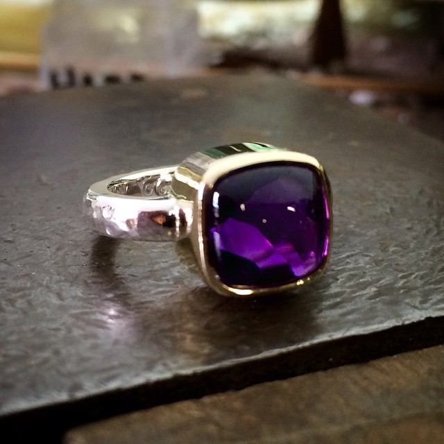 This little beauty is finished!! It's a buff top amethyst which means it's a smooth cabochon on top and faceted underneath so as you move the ring the light reflects and gives an amazing dreamy underwater look:) Set in 9ct Yellow Gold with a Sterling Silver Band Hey @robertaartglass check it out! It's a size N ?