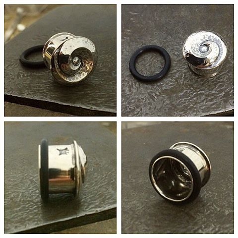 A present for my Dad xxx Its my first flesh tunnel plug. 12mm gauge, repousse and chased spiral front with a flared and groved back where the o ring sits. Sterling Silver.