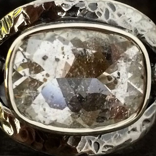 A close up of the Garnets in Quartz. Not a great shot but the little black dots are the Garnets. In real life you can see the brownish red of the Garnets. A beautiful reflective cut in this rock! A stunning and interesting gem! @laurenharrisjewellery